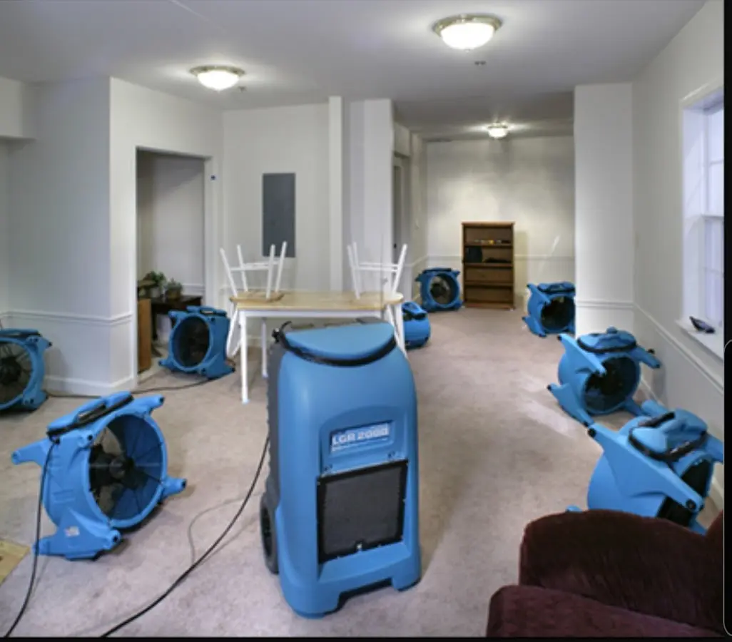 Air movers and dehumidifier setup for Water Damage Restoration in King