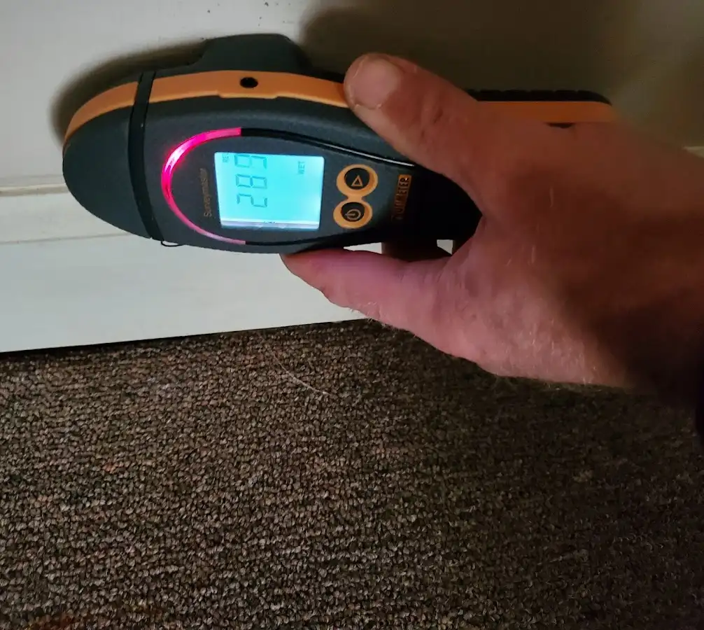 Moisture detection at baseboard during Storm Damage Restoration in King